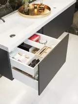 Elegant og moderne badeværelse inspiration med mørke marmorvægge, runde oplyste spejle med sort ramme, væghængt vaskeskab med dobbeltvask og en rummelig bruseniche